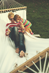 Image showing mom and a little daughter relaxing in a hammock