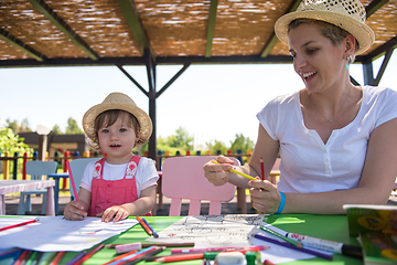 Image showing mom and little daughter drawing a colorful pictures