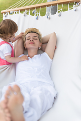 Image showing mother and a little daughter relaxing in a hammock