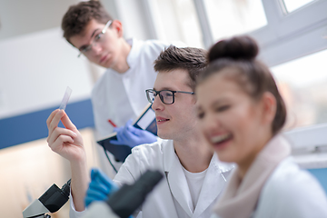 Image showing Group of young medical students doing research