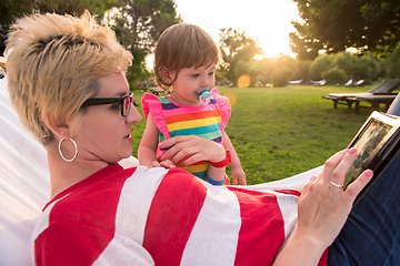 Image showing mom and a little daughter relaxing in a hammock