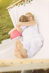 Image showing mother and a little daughter relaxing in a hammock