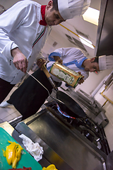 Image showing chef preparing food, frying in wok pan