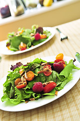 Image showing Green salad with berries and tomatoes