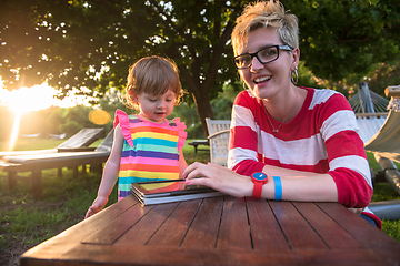 Image showing mom and her little daughter using tablet computer