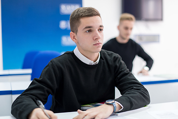 Image showing male student writing notes