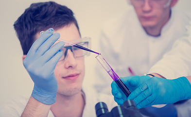 Image showing student with protective glasses making chemistry experiment