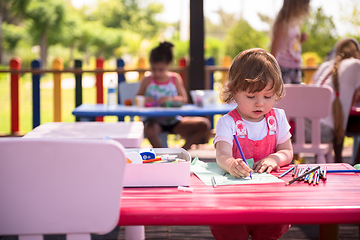 Image showing little girl drawing a colorful pictures