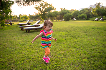 Image showing little girl spending time at backyard