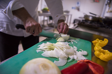 Image showing Chef hands cutting fresh and delicious vegetables