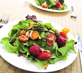 Image showing Green salad with berries and tomatoes