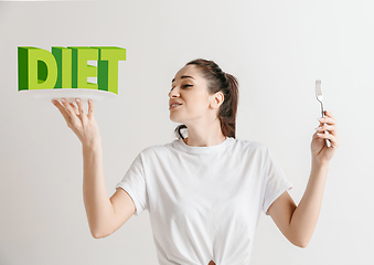 Image showing Food concept. Model holding a plate with letters of Diet