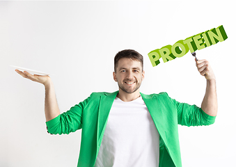 Image showing Food concept. Model holding a plate with letters of Protein