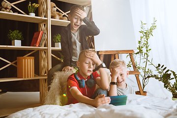 Image showing Little boys using different gadgets at home