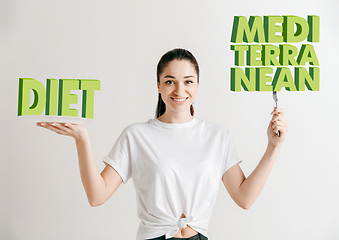 Image showing Food concept. Model holding a plate with letters of Diet, Mediterranean