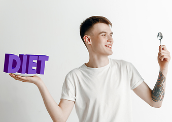 Image showing Food concept. Model holding a plate with letters of Diet