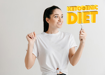 Image showing Food concept. Model holding a plate with letters of Ketogenic Diet