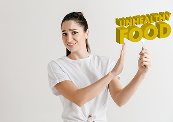 Image showing Food concept. Model holding a plate with letters of Unhealthy Food