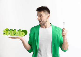 Image showing Food concept. Model holding a plate with letters of Salad