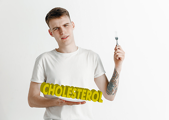 Image showing Food concept. Model holding a plate with letters of Cholesterol