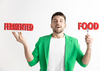 Image showing Food concept. Model holding a plate with letters of Fermented Food