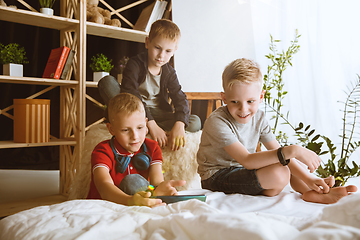 Image showing Little boys using different gadgets at home