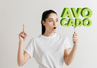 Image showing Food concept. Model holding a plate with letters of Avocado