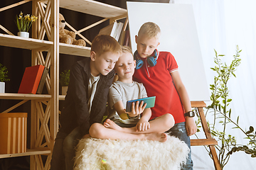 Image showing Little boys using different gadgets at home