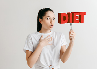 Image showing Food concept. Model holding a plate with letters of Diet