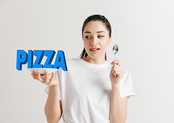 Image showing Food concept. Model holding a plate with letters of Pizza