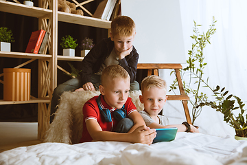 Image showing Little boys using different gadgets at home