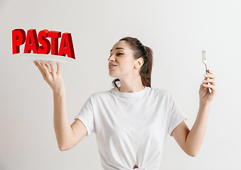 Image showing Food concept. Model holding a plate with letters of Pasta