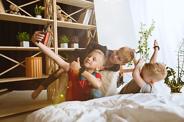 Image showing Little boys using different gadgets at home