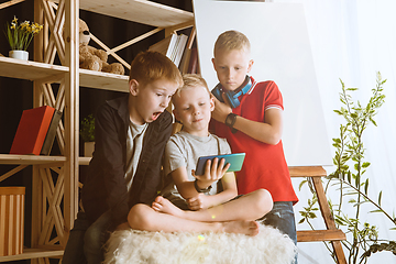 Image showing Little boys using different gadgets at home