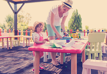 Image showing mom and little daughter drawing a colorful pictures