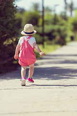 Image showing little girl runing in the summer Park