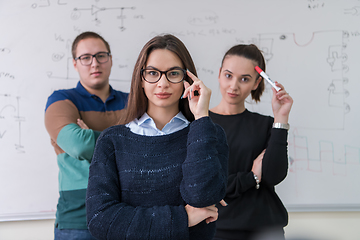 Image showing portrait of young students in front of chalkboard