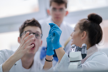 Image showing Group of young medical students doing research