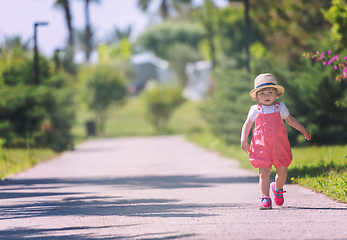 Image showing little girl runing in the summer Park