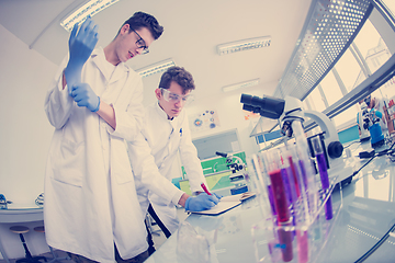 Image showing Group of young medical students doing research