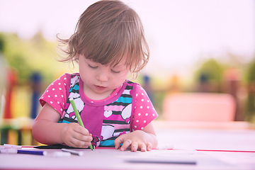 Image showing little girl drawing a colorful pictures