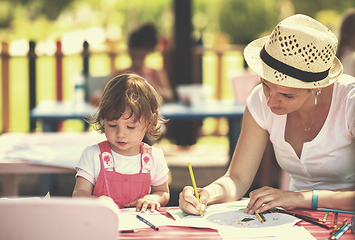 Image showing mom and little daughter drawing a colorful pictures