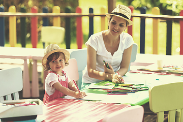 Image showing mom and little daughter drawing a colorful pictures