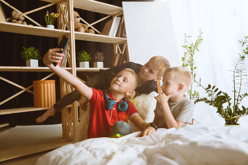 Image showing Little boys using different gadgets at home