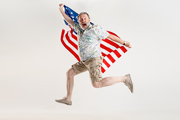 Image showing Senior man with the flag of United States of America