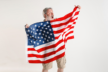 Image showing Senior man with the flag of United States of America