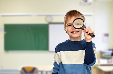 Image showing boy looking through magnifying glass at school