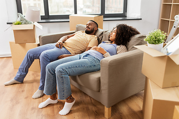 Image showing couple with boxes tired after moving to new home