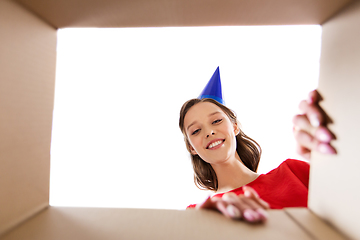 Image showing happy young woman looking into open birthday gift