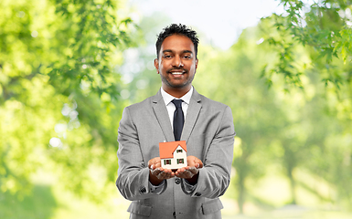 Image showing man realtor with house model and folder